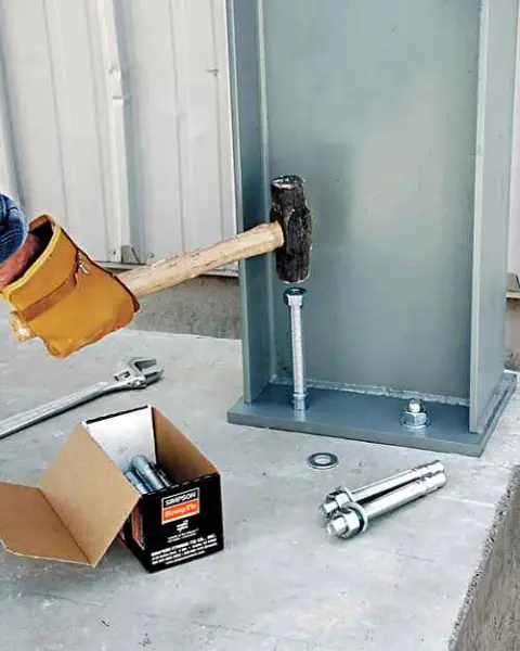 worker installing a wedge anchor